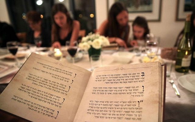 Illustrative: An Israeli family seen during the Passover seder meal on the first night of the eight-day long Jewish holiday, in Tzur Hadassah, on April 22, 2016. (Nati Shohat/ Flash 90)