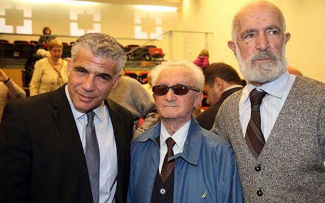 Illustrative: Yesh Atid Chairman Yair Lapid (left), at the Holot Institute of Technology for the Holocaust Survivors Conference on December 29, 2014. (Flash90)
