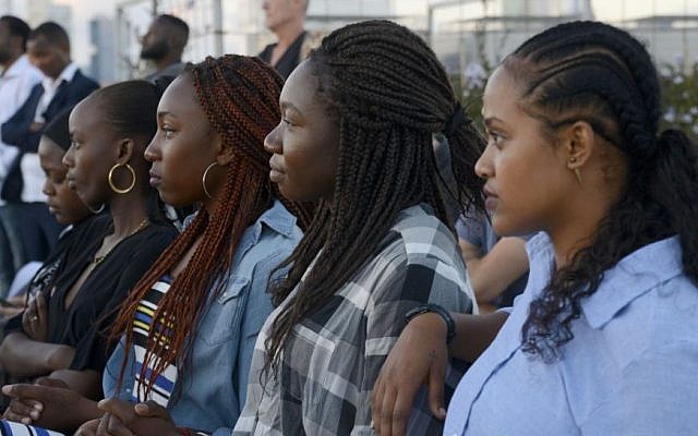 Illustrative: Supporters of the African Student Organization listen to asylum seekers talk about their experiences studying at Israeli universities in Tel Aviv, on June 21, 2017. (courtesy Eli Tesma)