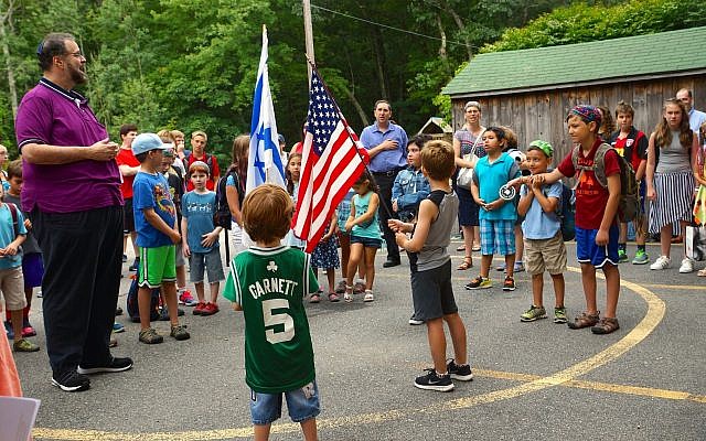 Illustrative: Scott Sokol, head of school at MetroWest Jewish Day School in Framingham, Massachusetts, leads morning circle, one of several camp-like elements the school has adopted. (Courtesy of  MetroWest Jewish Day School/via JTA)
