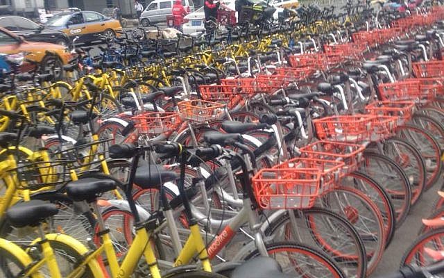 Photo of Mobikes (orange/silver) and ofo bikes (yellow) in Beijing on Feb 18 (courtesy of Rose-Golder-Novick)