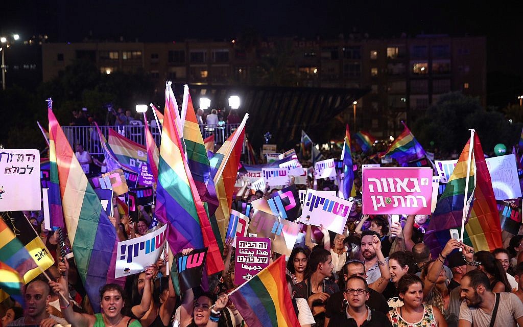 Members of the LGBT community and supporters participate in a protest against a Knesset bill amendment denying surrogacy for same-sex couples, at Rabin Square in Tel Aviv on July 22, 2018. (Miriam Alster/Flash90)