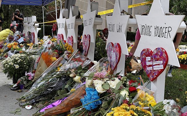 Flowers surround Stars of David on October 31, 2018, part of a makeshift memorial outside the Tree of Life Synagogue to the 11 people killed during worship services on Saturday October 27, 2018, in Pittsburgh. (AP Photo/Gene J. Puskar via Jewish News)