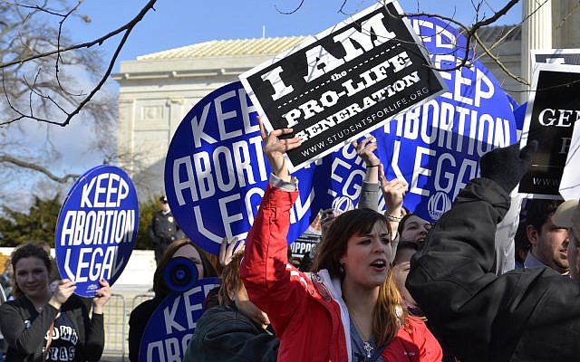 Washington D.C., USA - January 22, 2015; A Pro-Life woman clashes with a group of Pro-Choice demonstrators at the U.S. Supreme Court.