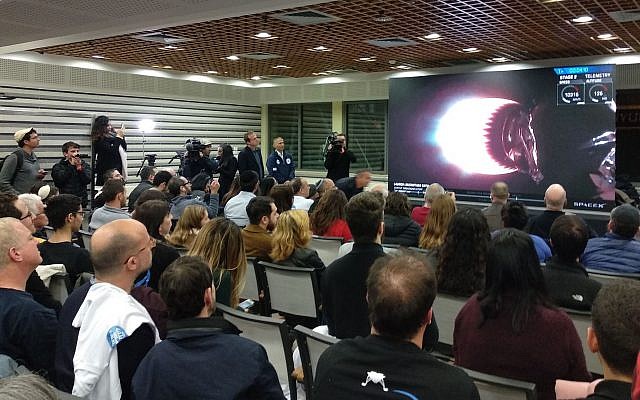 Hundreds of engineers and their families gathered in the Israel Aerospace Industries cafeteria in Yehud to watch a live feed of the launch of the Beresheet spacecraft on February 22, 2019. (Melanie Lidman/Times of Israel) 