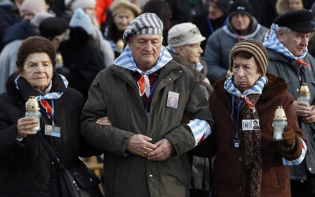 Survivors of Auschwitz, at the International Monument to the Victims of Fascism at Auschwitz II-Birkenau, walk to place candles on International Holocaust Remembrance Day in Poland, January 27, 2019. (Czarek Sokolowski/AP)