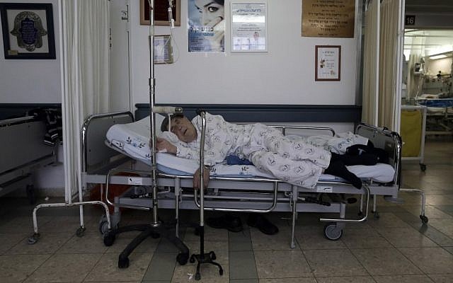 Illustrative photo of a patient kept in a corridor due to overcrowding at a hospital. (photo credit: Tsafrir Abayov/Flash90)
