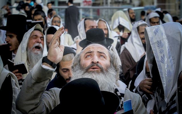 Illustrative. Ultra-Orthodox men gather in front of the Embassy of South Africa in Ramat Gan, during a demonstration in support of Eliezer Berland, who was then jailed in South Africa, , on April 25, 2016. (Roni Schutzer/Flash90/File)