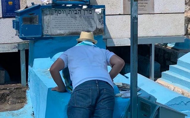 Men's access to the grave of Rabbi Yosef Caro zt"l, in Tsfat, Israel. The men are able to draw close enough to even kiss the grave. (Laura Ben David)