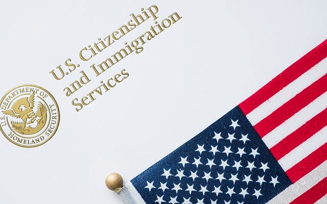 Envelope from U.S. Citizenship and Immigration Services with the American flag on top/U.S. immigration concept