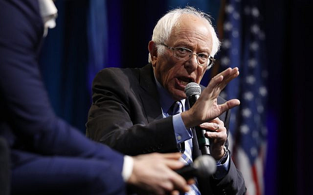 Democratic presidential candidate Bernie Sanders speaks at the J Street National Conference, with the 'Pod Save the World' hosts Tommy Vietor, left, and Ben Rhodes, October 28, 2019, in Washington. (AP Photo/Jacquelyn Martin)