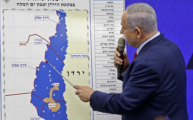 Israeli Prime Minister Benjamin Netanyahu points at a map of the Jordan Valley as he gives a statement in Ramat Gan, near the Israeli coastal city of Tel Aviv, on September 10, 2019. - Israeli Prime Minister Benjamin Netanyahu issued a deeply controversial pledge on September 10 to annex the Jordan Valley in the occupied West Bank if re-elected in September 17 polls. He also reiterated his intention to annex Israeli settlements throughout the West Bank if re-elected, though in coordination with US President Donald Trump, whose long-awaited peace plan is expected to be unveiled sometime after the vote. (Menahem KAHANA / AFP)