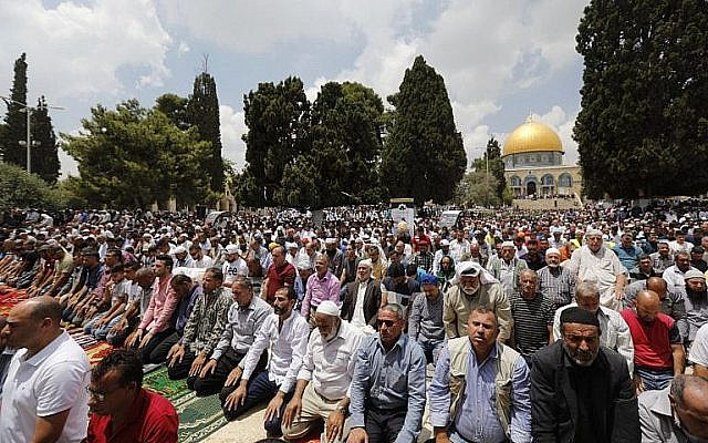 Illustrative. Muslim worshipers pray near the Dome of the Rock and the Al-Aqsa Mosque, located on the Temple Mount compound in Jerusalem, during Friday prayers in the Muslim holy month of Ramadan on June 1, 2018. (AFP Photo/Ahmad Gharabli/File)