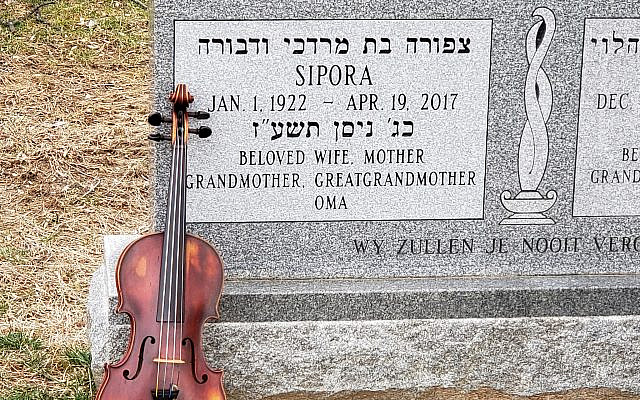 Bram's violin up against the tombstone of his sister Sipora. (Courtesy)