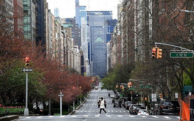 A woman walks on an empty Park Avenue in New York City on April 10, 2020. (Johannes Eisele/AFP)
