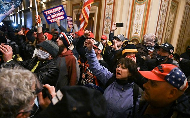 Supporters of US President Donald Trump protest inside the US Capitol on January 6, 2021, in Washington, DC. - Demonstrators breeched security and entered the Capitol as Congress debated the a 2020 presidential election Electoral Vote Certification. (Photo by ROBERTO SCHMIDT / AFP)