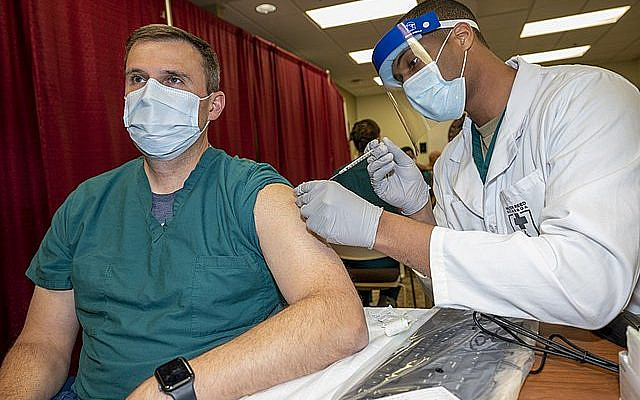 Army Col. Sean Dooley, a doctor at Walter Reed National Military Medical Center, receives a COVID-19 vaccination, Walter Reed National Military Medical Center, Bethesda, Md., Dec. 14, 2020. (DoD photo by Lisa Ferdinando)