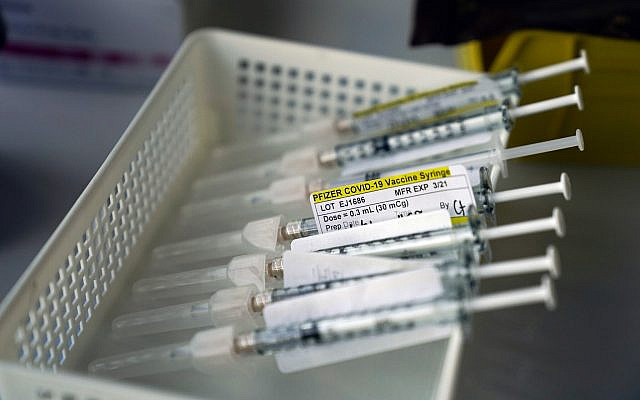 Syringes containing the Pfizer-BioNTech COVID-19 vaccine sit in a tray in a vaccination room at St. Joseph Hospital in Orange, California, January 7, 2021. (AP Photo/ Jae C. Hong)