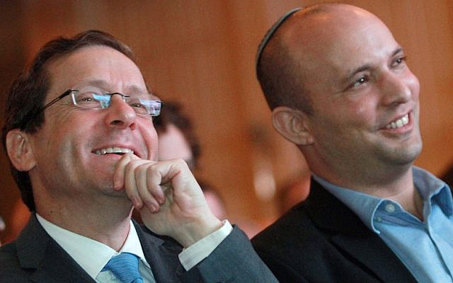 Zionist Union leader Isaac Herzog, left, and Jewish Home chair Naftali Bennett listen to a debate on the economy in Tel Aviv, March 11, 2015. (Gil Cohen Magen/AFP/Getty Images)