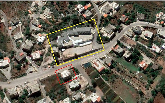 An alleged Hezbollah weapons depot (outlined in red) is seen across the street from a school (outlined in yellow) in the central Lebanese town of Ebba in a satellite image from June 1, 2020. (Google Earth, outlines added by The Times of Israel)