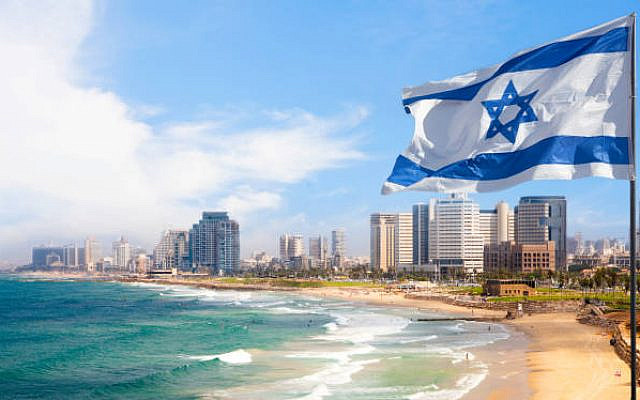 Illustrative. A Tel Aviv beach during the summer, with an Israeli flag. (iStock)