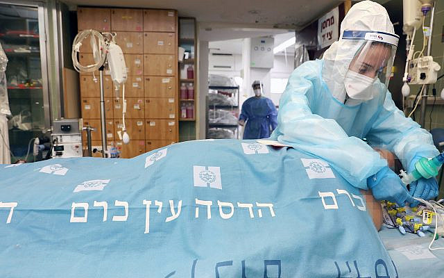 Coronavirus Intensive Care Unit Nurse Ilana Abitbol assists a patient connected to an ECMO extracorporeal membrane oxygenation machine at Hadassah Ein Kerem Medical Center in Jerusalem.