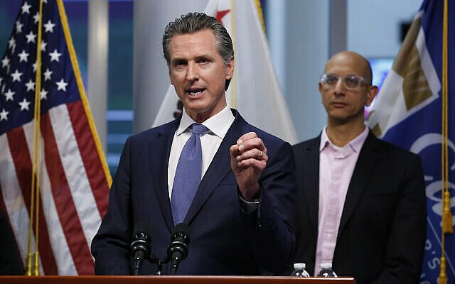 California Gov. Gavin Newsom gives an update to the state's response to the coronavirus, at the Governor's Office of Emergency Services in Rancho Cordova Calif., Tuesday, March 17, 2020. At right is California Health and Human Services Agency Director Dr. Mark Ghaly. (AP Photo/Rich Pedroncelli, Pool)