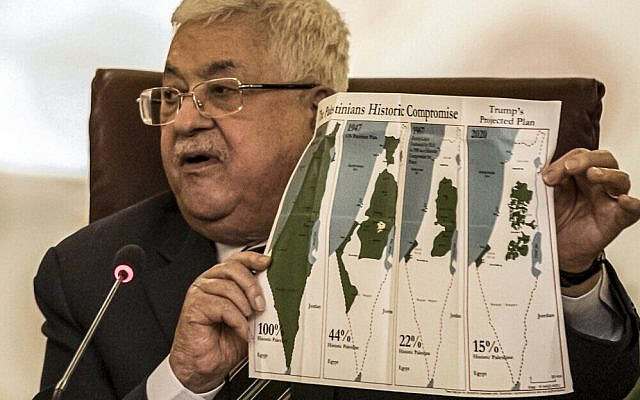 Palestinian Authority President Mahmoud Abbas holds a placard showing maps of (L to R) historical Palestine, the 1947 United Nations partition plan on Palestine, the 1948-1967 borders between the Palestinian territories and Israel, and a current map of the Palestinian territories without Israeli-annexed areas and settlements, as he attends an Arab League emergency meeting discussing the US-brokered proposal for a settlement of the Middle East conflict at the league headquarters in the Egyptian capital Cairo on February 1, 2020 (Khaled DESOUKI / AFP)