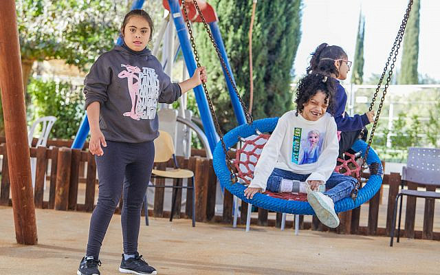 ADI Negev-Nahalat Eran special education students with severe disabilities play together at the rehabilitation village's accessible playground.