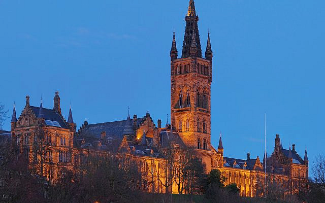 The University of Glasgow’s main building at night. (Wikipedia/Photo by DAVID ILIFF. License: CC BY-SA 3.0 / https://creativecommons.org/licenses/by/3.0/legalcode. Via Jewish News.)