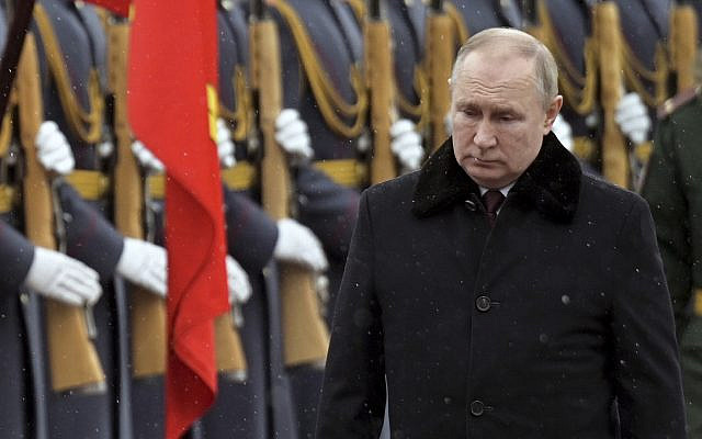 Russian President Vladimir Putin attends a wreath-laying ceremony at the Tomb of the Unknown Soldier, near the Kremlin Wall, during the national celebrations of the 'Defender of the Fatherland Day' in Moscow, Wednesday, Feb. 23, 2022. (Alexei Nikolsky, Kremlin Pool Photo via AP)