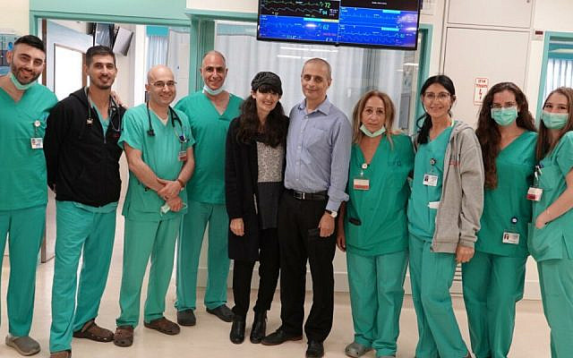 Eliezer and Shira Be'eri with doctors and nurses of the cardiac intensive care unit at Shaare Zedek Hospital (Courtesy Shaare Zedek Hospital)
