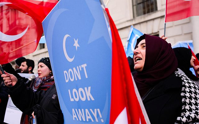 A woman seen shouting slogans while holding a placard during a protest against the Chinese policies in Xinjiang.
(Via Jewish News)
