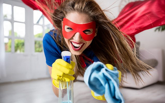 Woman superhero flying through the room with a mop