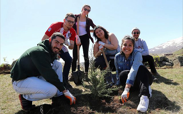 Participants of Birthright Armenia plant a tree in the Aragatsotn region, near the village of Sasunik, as part of the Armenia Tree Project. Since its founding in 1994, the project has planted more than 6.5 million trees throughout the country. (Photo courtesy of Birthright Armenia)