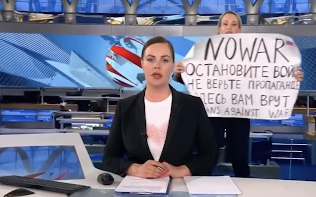 Marina Ovsyannikova, a Russian state TV employee interrupts the evening news broadcast, holding a sign condemning President Vladimir Putin's war against Ukraine on March 14, 2022. She was arrested shortly after. (Screen capture/Twitter)
