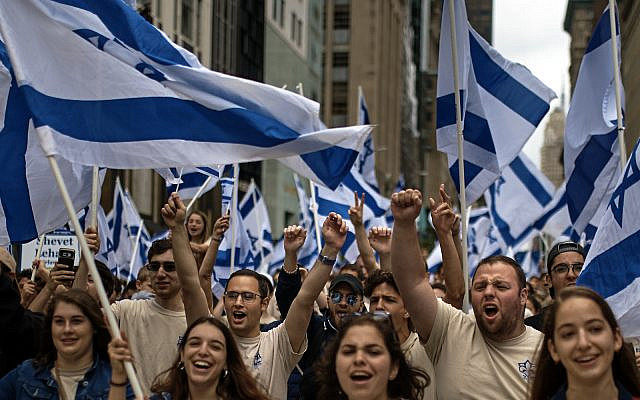 People carry Israeli flags as they march during the annual Celebrate Israel parade, Sunday, June 3, 2018, in New York. (AP Photo/Andres Kudacki)