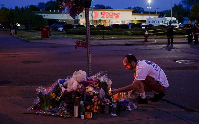 A person pays his respects at a makeshift memorial outside the scene of a shooting at a supermarket in Buffalo, New York, May 15, 2022. (AP Photo/Matt Rourke, File)