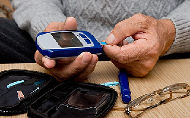 Concept diabetes in the elderly retired. Senior man with glucometer checking blood sugar level at home. Learn to use a glucometer