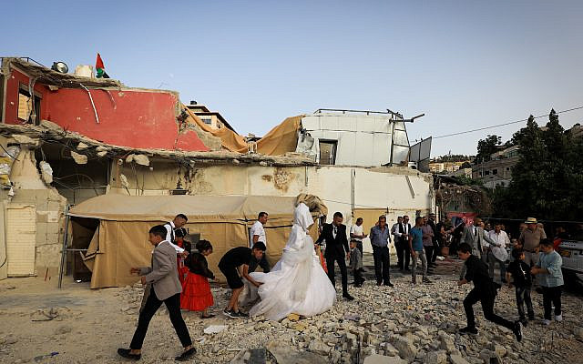 Illustrative: A Palestinian couple celebrate their wedding at a building that was demolished by Israeli authorities, in the East Jerusalem neighbourhood of Silwan, on June 11, 2022 (Jamal Awad/Flash90)