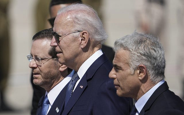 President Joe Biden, center, Israeli President Isaac Herzog, left, and Israeli Prime Minister Yair Lapid, walk during a welcoming ceremony after Biden arrived at Ben Gurion Airport, near Tel Aviv, Israel, Wednesday, July 13, 2022. Biden arrives in Israel on Wednesday for a three-day visit, his first as president. He will meet Israeli and Palestinian leaders before continuing on to Saudi Arabia. (AP Photo/Ariel Schalit)