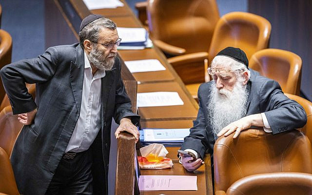 MK Moshe Gafni (left) with United Torah Judaism (UTJ) party colleague Meir Porush, in the Knesset, June 22, 2022. The UTJ party is one of two ultra-Orthodox parties in Knesset that will not include women in their lists. (Olivier Fitoussi/ Flash90)