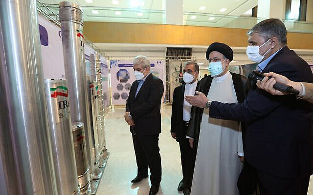 Iran’s President Ebrahim Raisi, second right, listens to an explanation while viewing an advanced centrifuge at an exhibition of Iran’s nuclear achievements in Tehran, Iran on April 9, 2022. (Iran President’s Office)