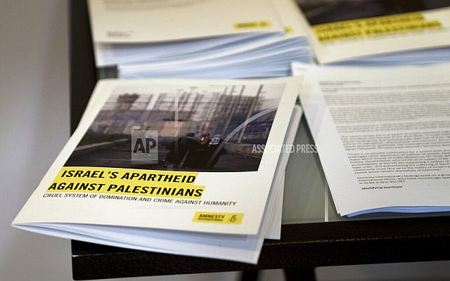 Copies of Amnesty International's report "Israel's Apartheid Against Palestinians," are available for journalists at a press conference in Jerusalem, Tuesday, Feb. 1, 2022. The London-based rights group said Tuesday that Israel has maintained "a system of oppression and domination" over the Palestinians going all the way back to its establishment in 1948, one that meets the international definition of apartheid. (AP Photo/Maya Alleruzzo)