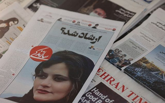 A newspaper with a cover picture of Mahsa Amini, a woman who died after being arrested by the Islamic republic's "morality police" is seen in Tehran, Iran September 18, 2022. Majid Asgaripour/WANA (West Asia News Agency)