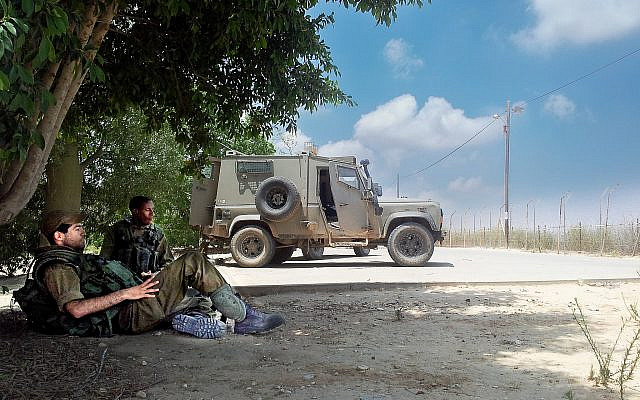 Soldiers resting on Nirim. Photo credit Adele Raemer