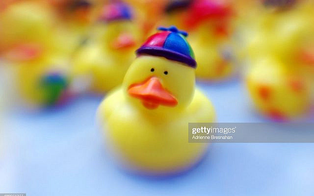 Artistically blurred Lensbaby shot of rubber ducks on a blue background.