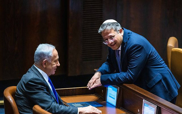 Likud leader MK Benjamin Netanyahu with Otzma Yehudit party head Itamar Ben Gvir at a vote in the assembly hall of the Knesset on December 28, 2022. (Olivier Fitoussi/Flash90)