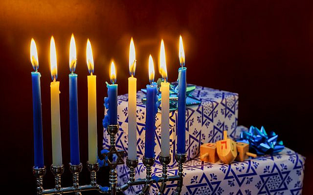Hanukkah menorah, dreidels, and presents. (iStock)