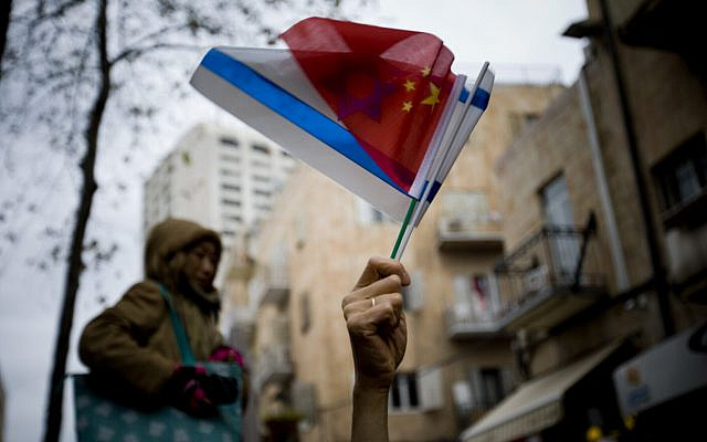 A Chinese tourist waves an Israeli and Chinese flags during a celebration for the Chinese lunar new year in Jerusalem, February 3, 2011. (AP Photo/Ariel Schalit)
